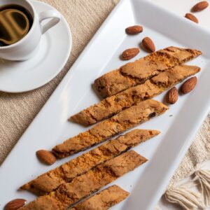 almond-biscotti on white plate and cup of coffee