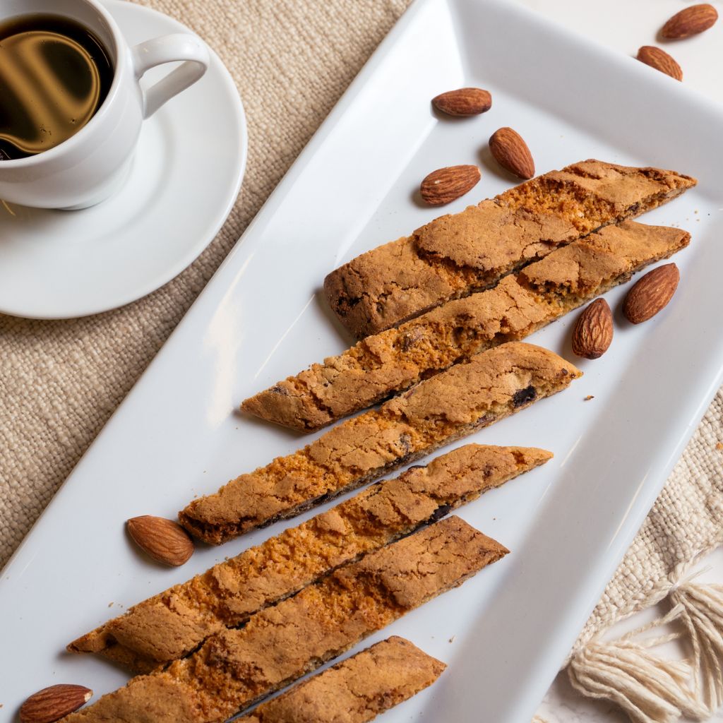 almond-biscotti on white plate and cup of coffee