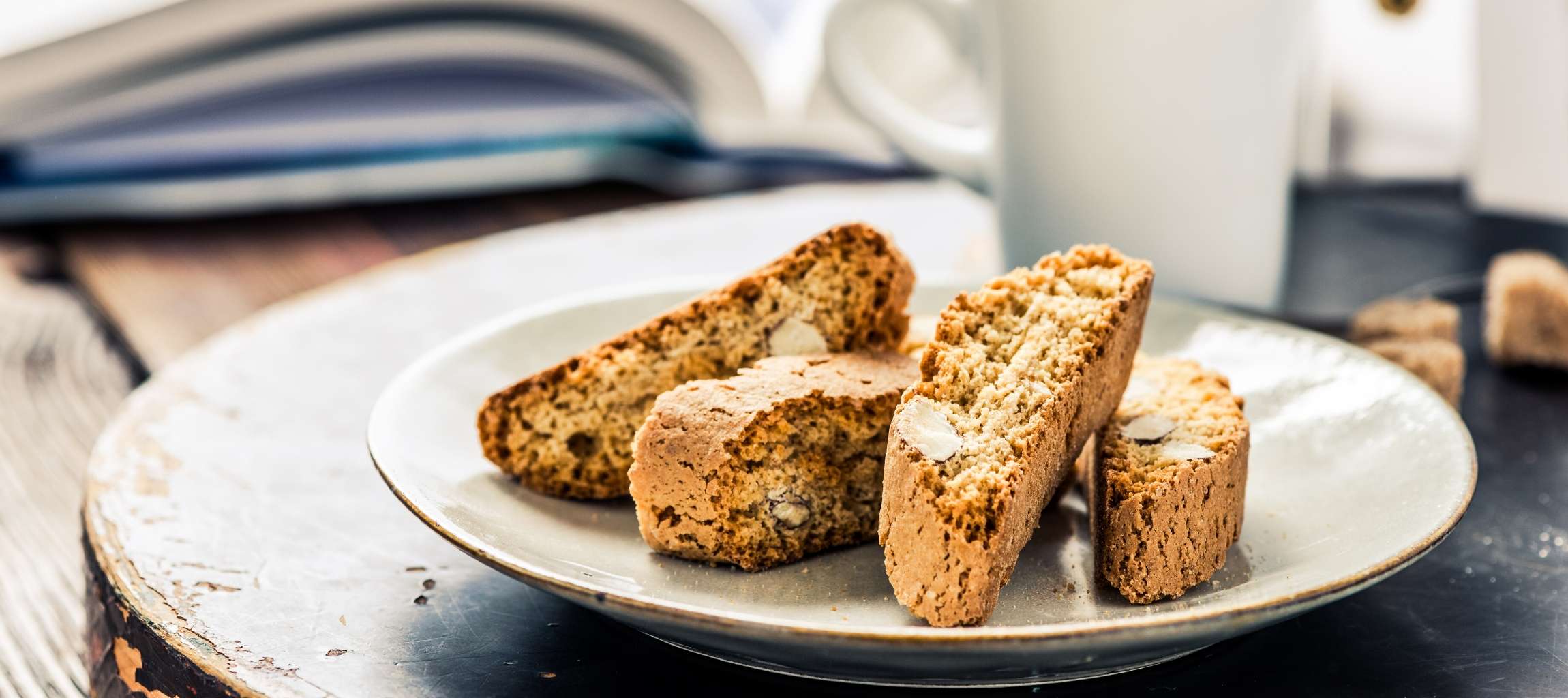 Almond biscotti on a plate sitting on a table in a cozy room