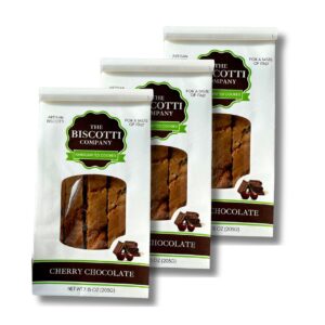 Three white biscotti cookie packages labeled The Biscotti Company, Cherry Chocolate flavor, with windows showing cookies in front of a white background.