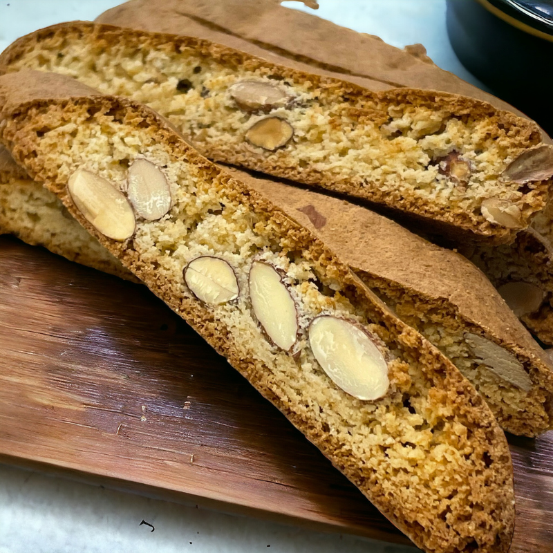 Crisp gluten-free almond biscotti slices cooling on a baking tray