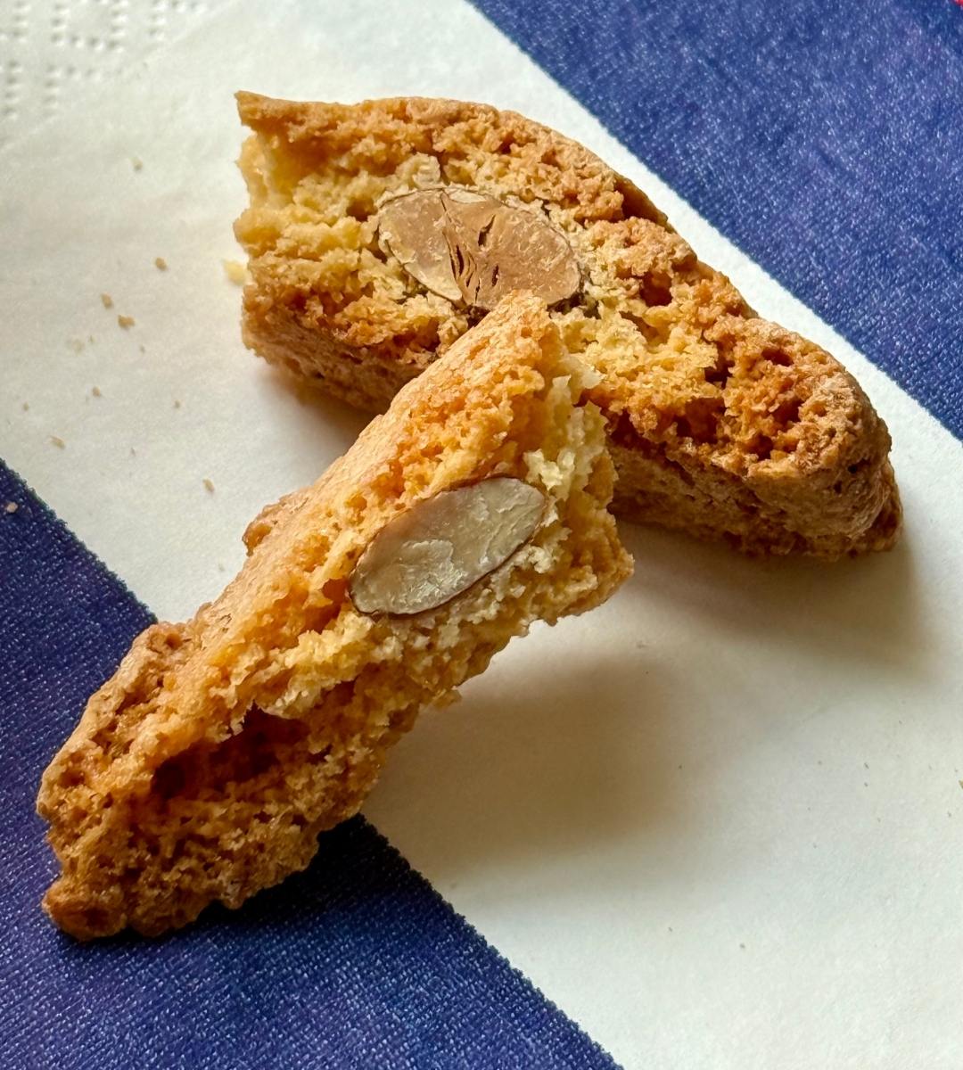 Biscotti snapped in half showing nuts, chocolate, and airy interior