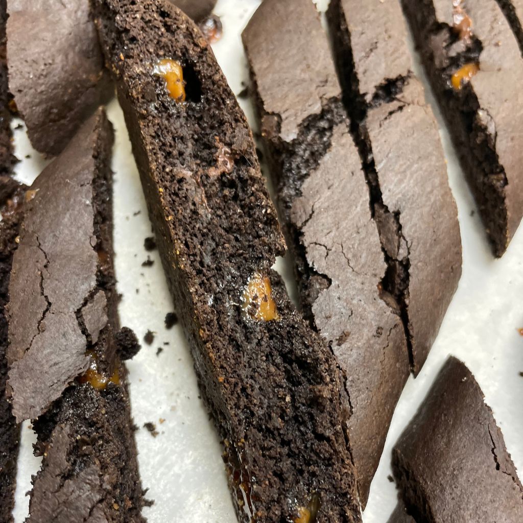 Gluten free double chocolate biscotti with cocoa in the dough and pieces of salted caramel baked through.