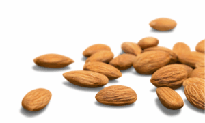 Whole roasted almonds scattered on a table ready to be used in almond biscotti