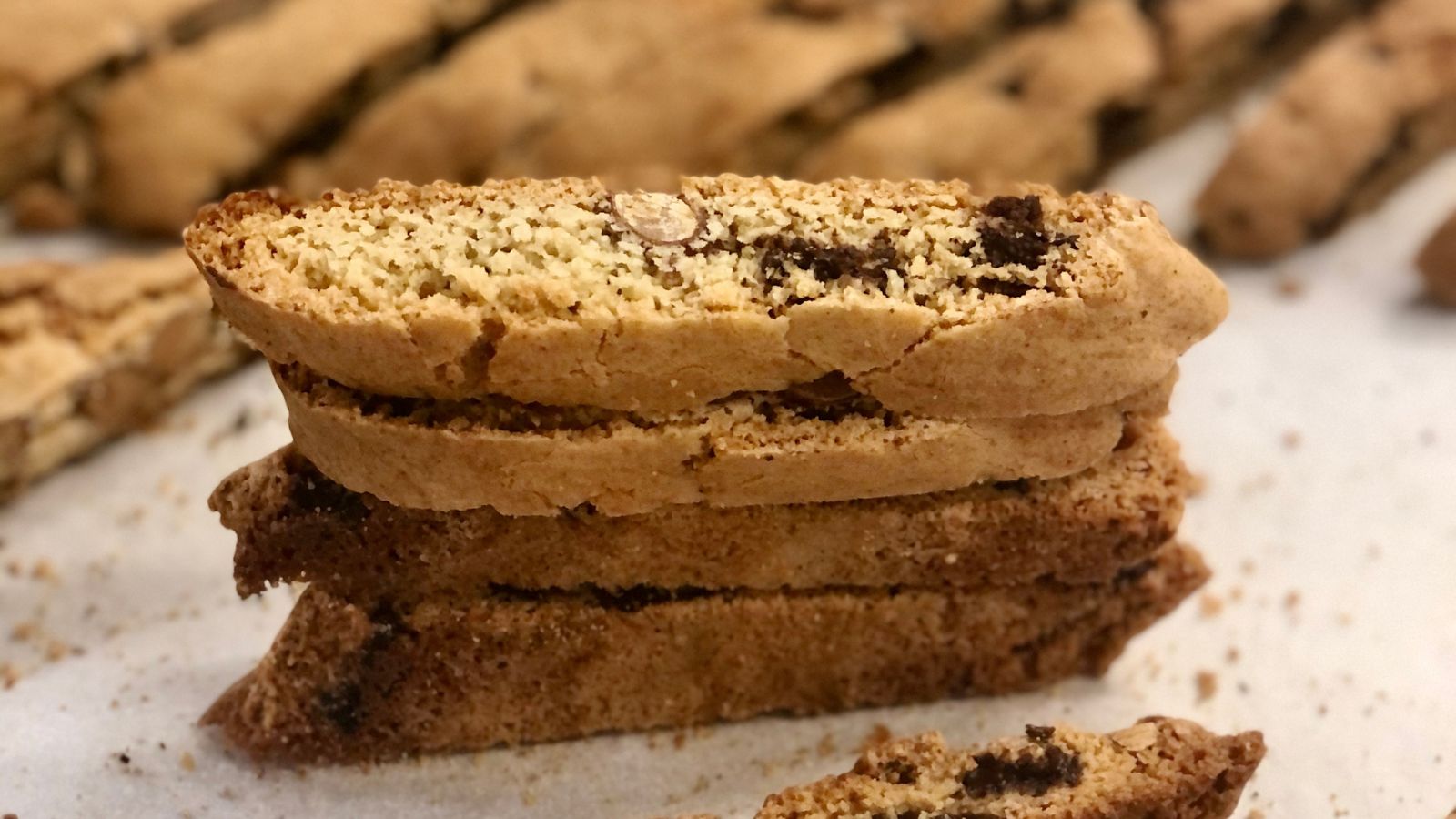 Chocolate almond biscotti with whole roasted almonds and Belgian semisweet chocolate chunks visible in every piece