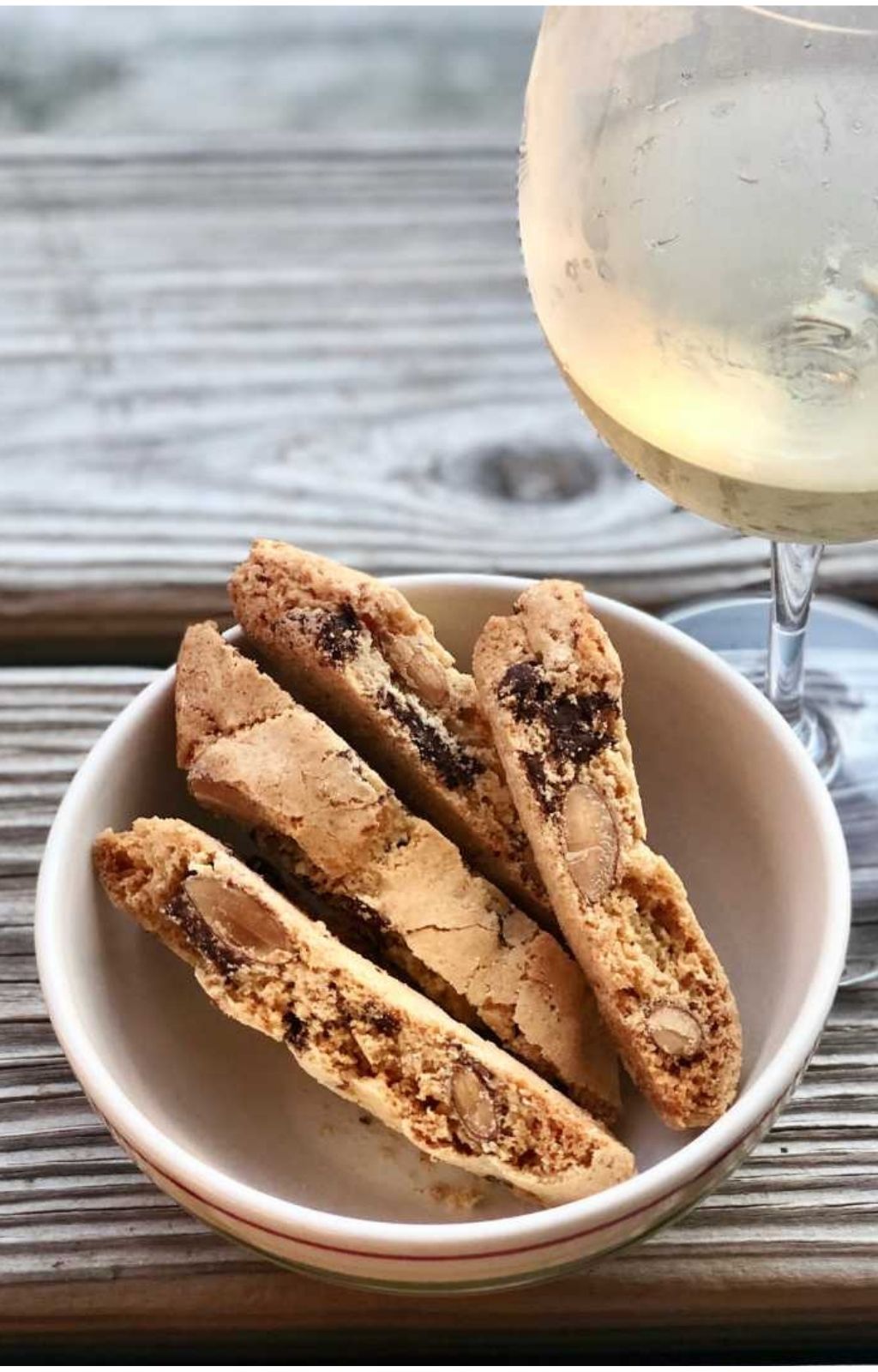 Chocolate almond biscotti served alongside a glass of vin santo dessert wine