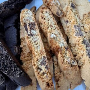 Closeup of The Biscotti Company Chocolate Pecan & Salted Caramel biscotti slices with pecans and chocolate