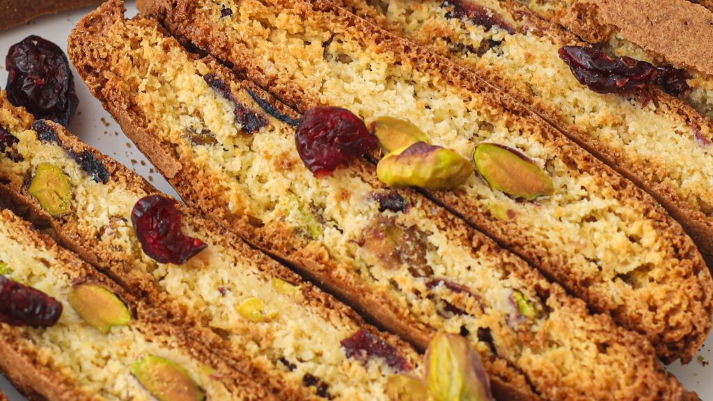 Close-up of cranberry pistachio biscotti cookies with whole pistachios and dried cranberries.
