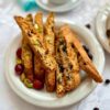 Cranberry pistachio biscotti on a plate with coffee and tea pairing