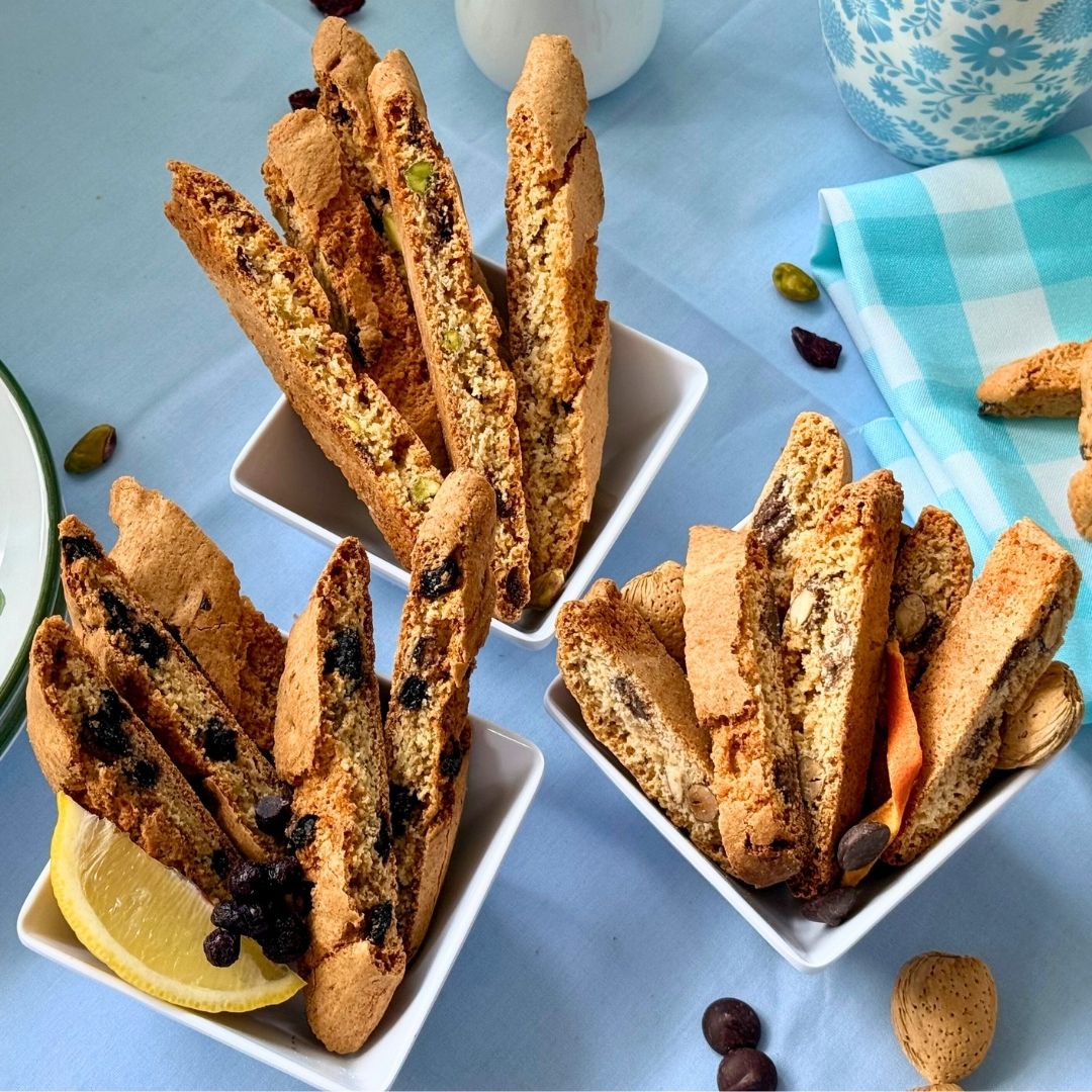 Spring Bundle biscotti in bowls: cranberry pistachio, blueberry lemon, and dark chocolate orange almond