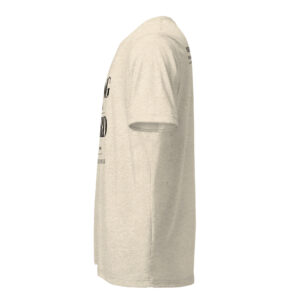 Side view of a beige short-sleeve T-shirt worn on a form, showing printed black text along the front and sleeve edge.