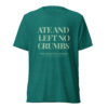 Back view of a teal heather T-shirt with large light text reading 'ATE AND LEFT NO CRUMBS'.