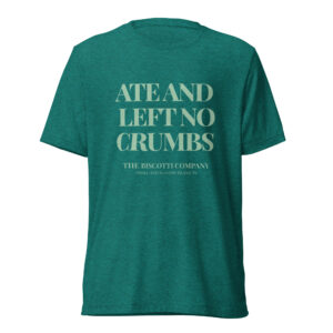 Back view of a teal heather T-shirt with large light text reading 'ATE AND LEFT NO CRUMBS'.