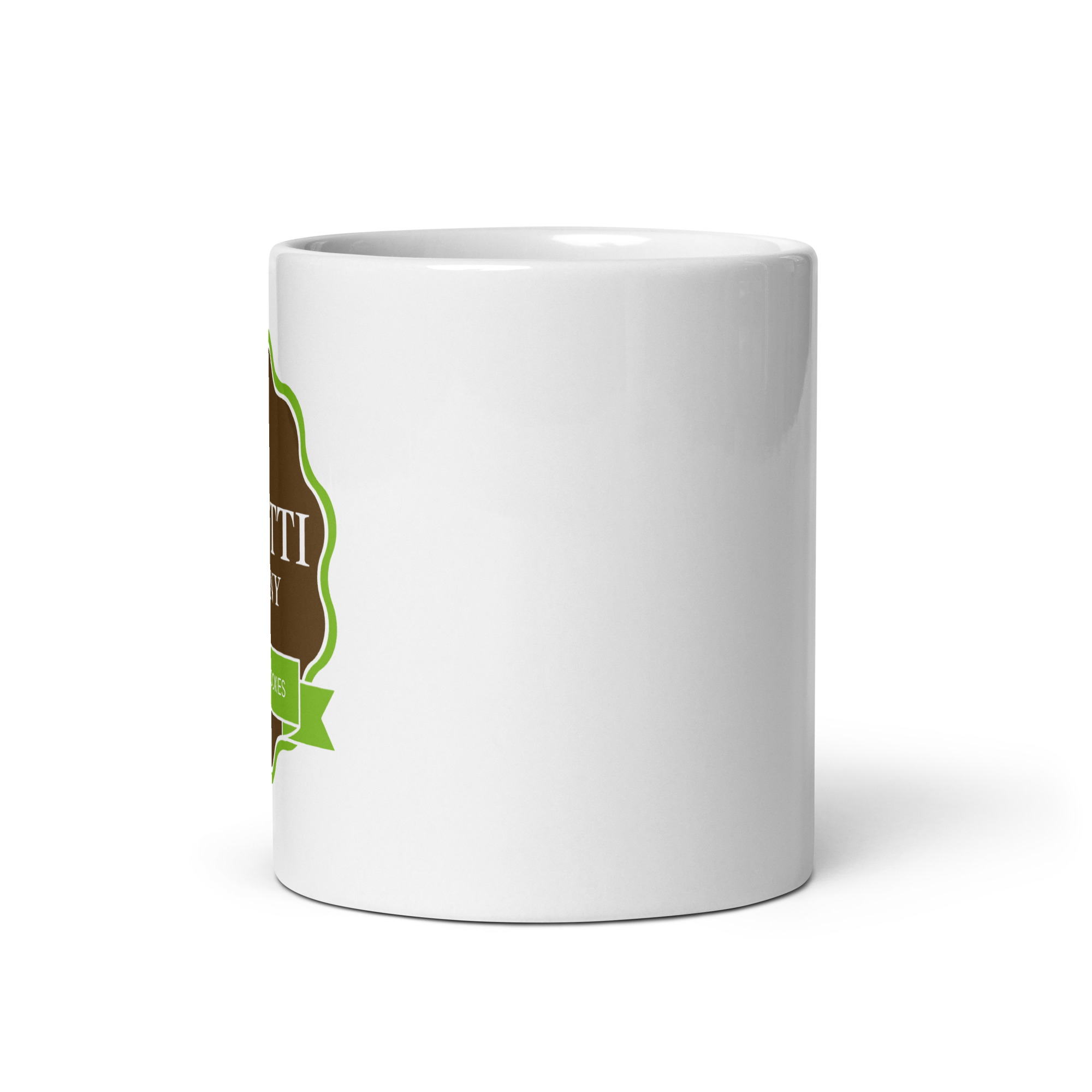 Close-up of a white ceramic mug with a brown and green decorative label along the left edge.