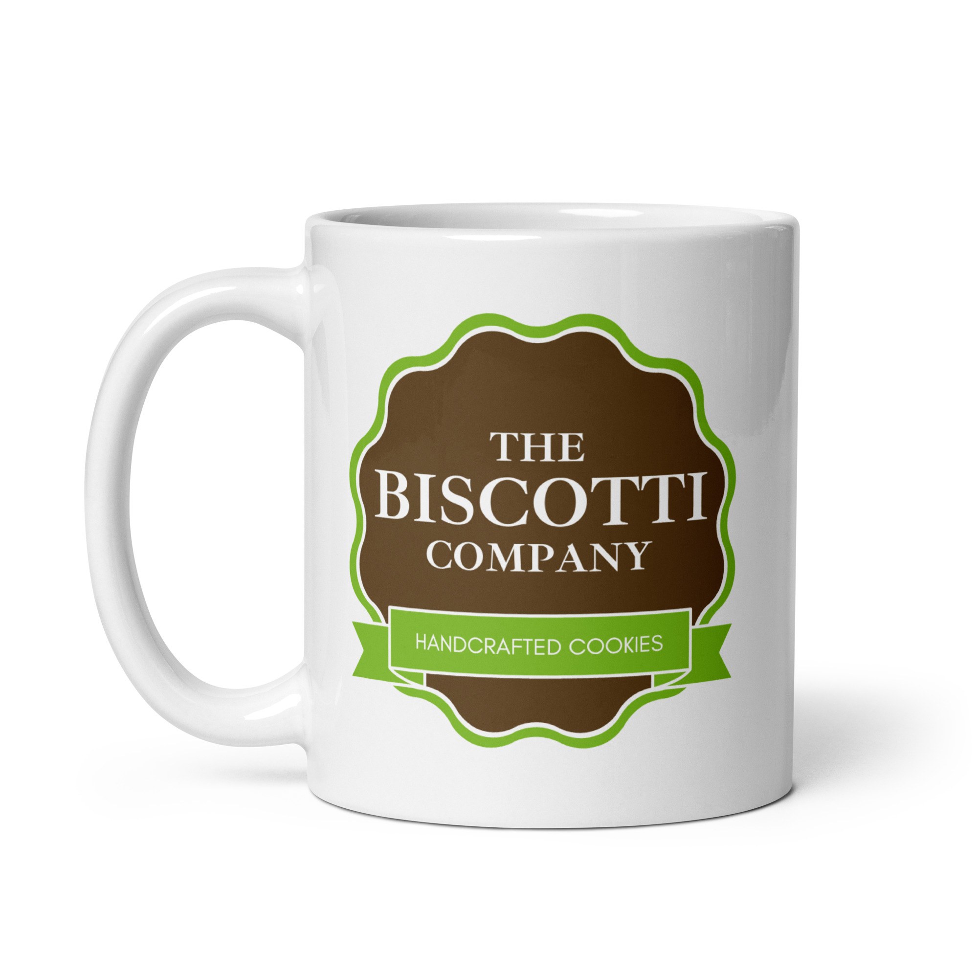 White ceramic mug featuring a brown circular label with 'THE BISCU... COMPANY' and a green ribbon reading 'HANDCRAFTED COOKIES'