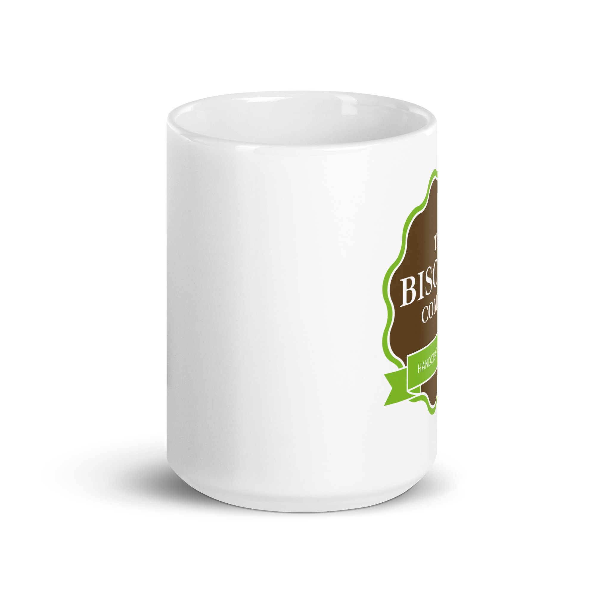 Close-up of a white ceramic mug with a brown curved label and green ribbon on the side.