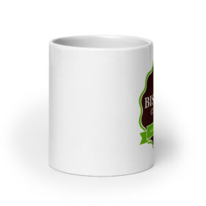 Close-up of a white ceramic mug with a partial green and brown label on the right, against a white background.