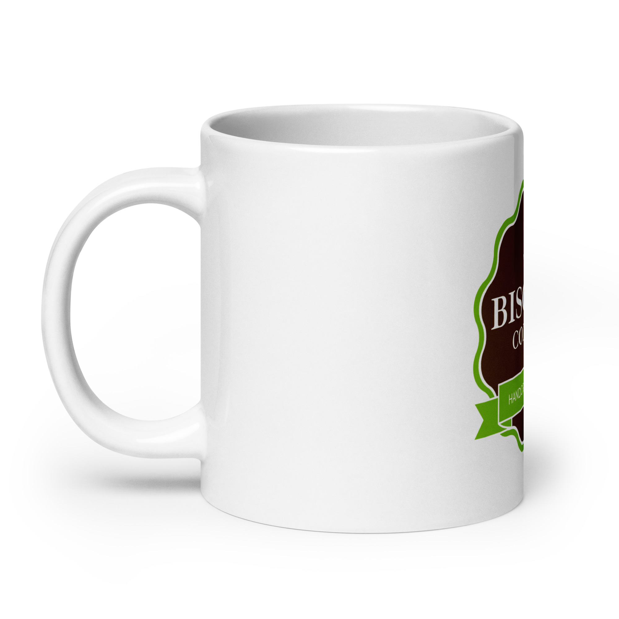 Close-up of a white ceramic mug with a partial decorative label on the right side and a curved handle on the left.