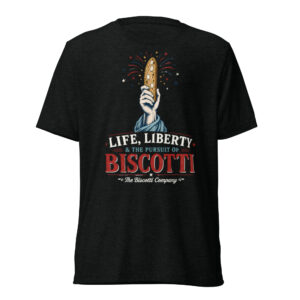 Raised hand holding a tall biscotti with fireworks, on a dark T‑shirt, slogan: 'Life, Liberty & The Pursuit of Biscotti'