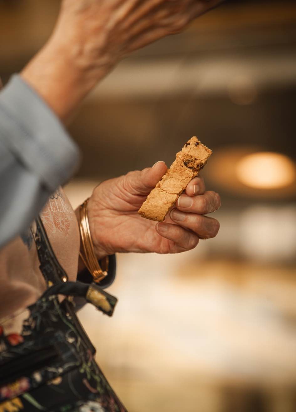 Customer tastes a biscotti while exploring flavors during The 2026 Biscotti Report tasting in Mattituck